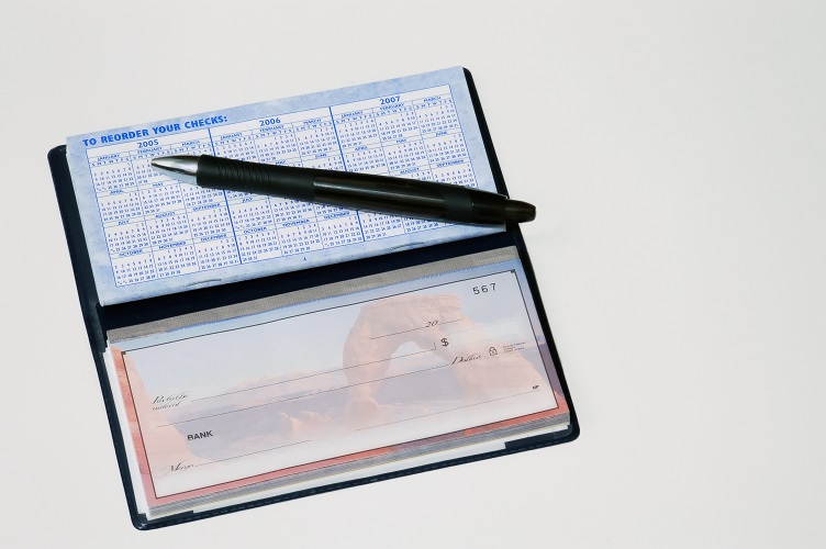 Photo of a checkbook and a pen